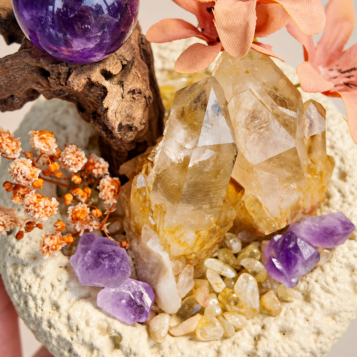 Close-up of golden citrine, purple amethyst pieces and decorative flowers