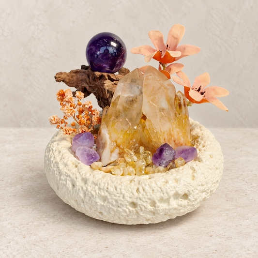 Citrine cluster and amethyst sphere crystal garden in a cream textured bowl with wood and floral accents