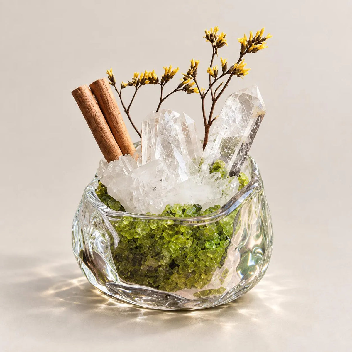 Mini clear quartz and peridot crystal garden in a textured glass bowl.
