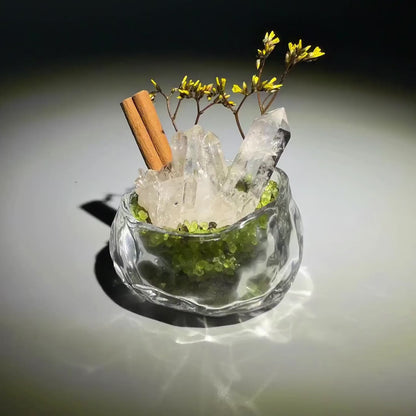 Finished clear quartz and peridot crystal garden in sunlight.