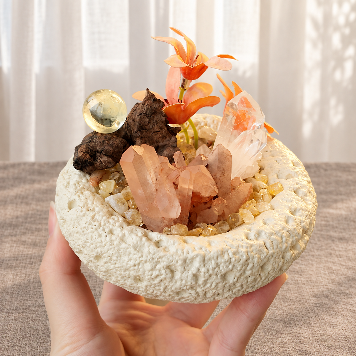 Angled view of red quartz formations, golden citrine sphere and peach floral accents