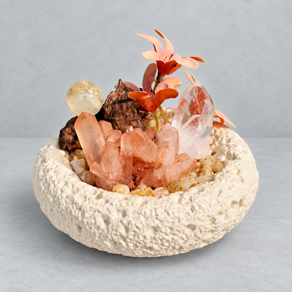 Red quartz cluster, included quartz point and citrine sphere in a cream textured bowl with floral and wood accents
