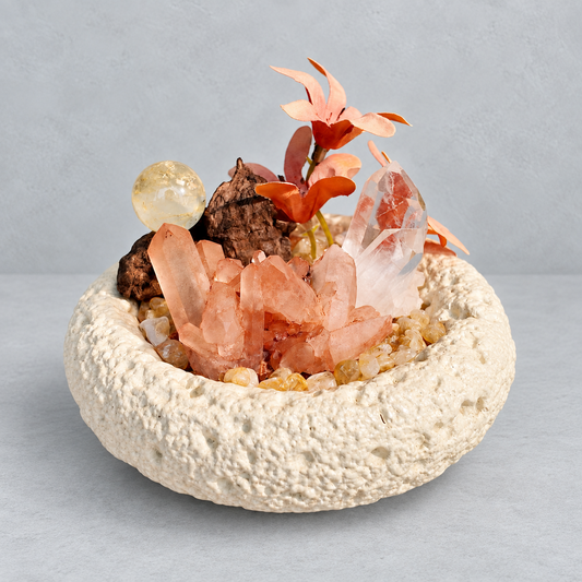 Red quartz cluster, included quartz point and citrine sphere in a cream textured bowl with floral and wood accents
