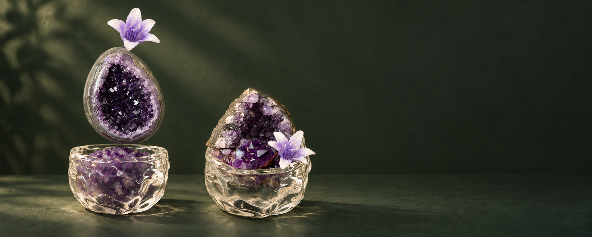 Exploded amethyst garden with a natural geode and purple stone-filled glass bowl beside a complete crystal garden.