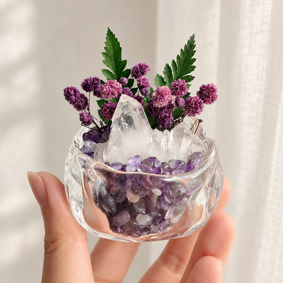 Miniature purple floral crystal garden held in a hand for scale